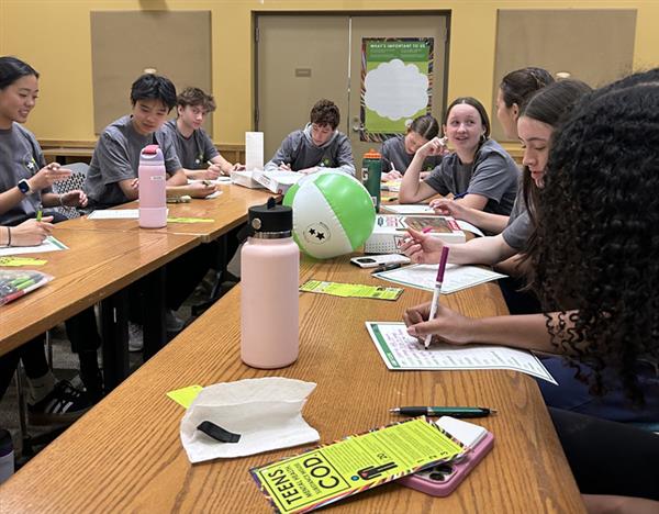 STUDENTS AT TABLE WRITING