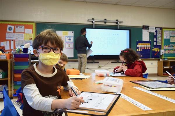student working on math worksheet