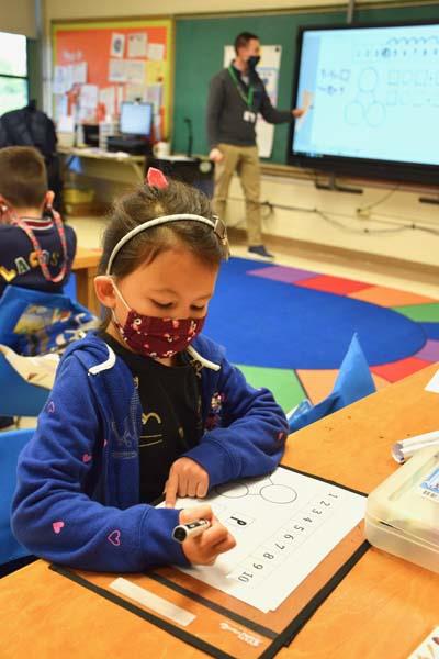 student working on math worksheet