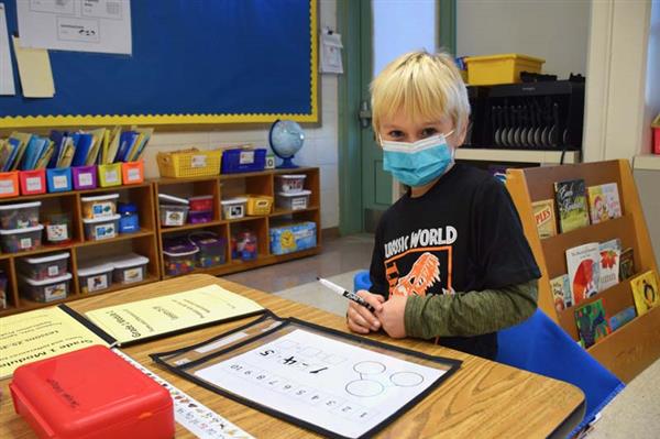 student working on math worksheet