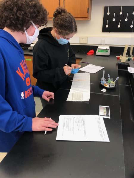 students examining lactaid pills in a lab experiment